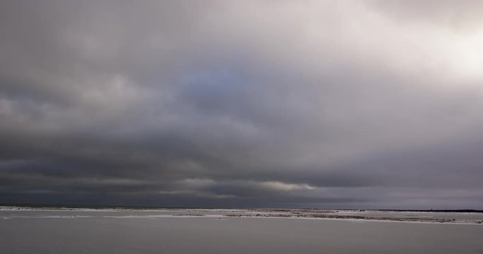 Time lapse clouds rolling over frozen Tundra in Canada