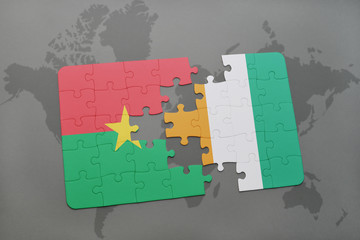 puzzle with the national flag of burkina faso and cote divoire on a world map