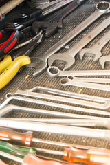 Fototapeta premium Work tools in a car garage vehicle repair. screwdriver for car fix on duty. Set of tolls in a case. Close up