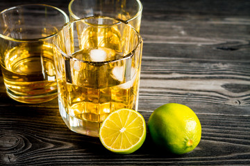 glass of whiskey on dark wooden background