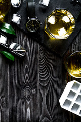 glass of scotch on dark wooden background top view