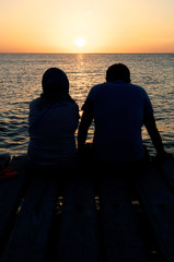 young couple on a pier at sunset