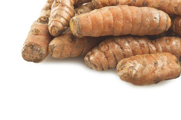 turmeric root and some slices on a white background