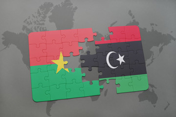 puzzle with the national flag of burkina faso and libya on a world map