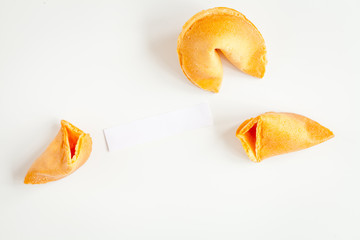 Chinese fortune cookie with prediction on white background top view