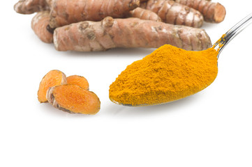 dust of ground turmeric on the spoon