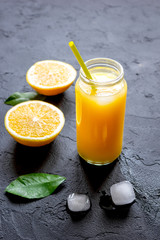 freshly squeezed orange juice on dark background