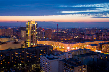 Evening cityscape from rooftop. Houses, night lights, skyscraper Voronezh Trade Center Gallery of Chizhov. Voronezh downtown