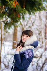 Young beautiful girl  standing near the tree