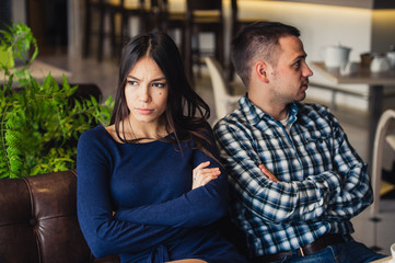Couple at cafe during lunch. They are taking offense and sitting back