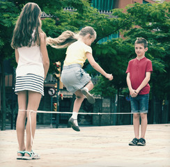 Kids skipping on  elastic rope