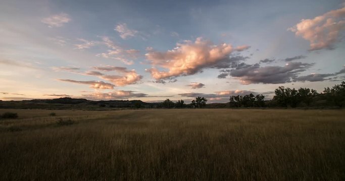 Morning Time lapse of sunlight on clouds above Montana prairie in summer