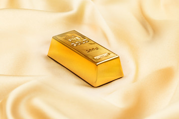 Golden ingot on silk