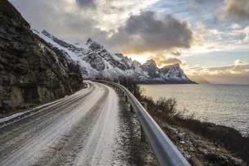 Norwegian landscape with a tiny road along the seaside in a fjord in the winter, Nordland, Norway