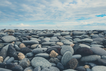pebble stones, rocks and blue sky horizon