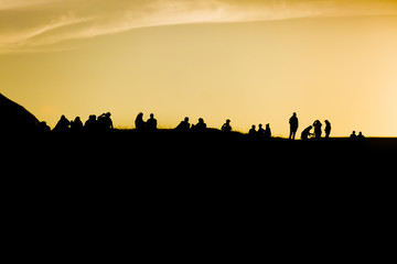Traena festival 2014, people standing on the top of a hill dmiring the midnight sun