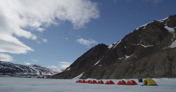 Time lapse - Clouds over mountain tents on sea ice