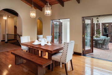 Table and open french doors in dark wood  n mediterranean style