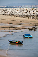 Fototapeta premium Boats in the little harbour of Cova do Vapor near Lisbon, Portugal