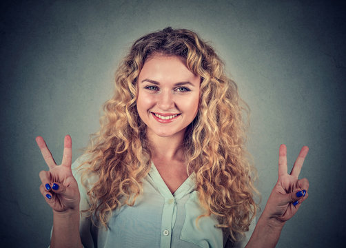 Happy teenage girl showing victory or peace sign