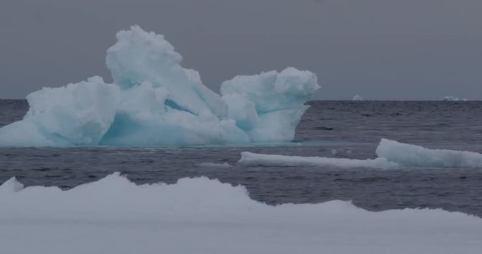 Large blue iceberg drifting past ice edge