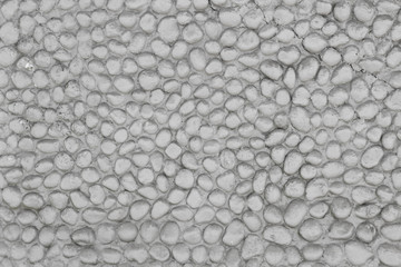 Stone river wall. Cement wall with river stones placed at random.
