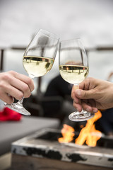 Celebration. People holding glasses of white wine making a toast