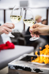 Celebration. People holding glasses of white wine making a toast
