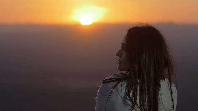 breathless sunset: woman contemplates beautiful scenario relaxing herself