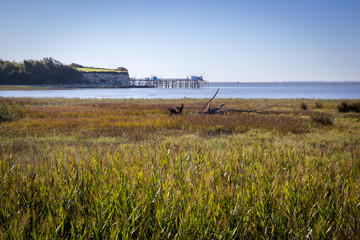 maritime seaside landscape of the Gironde estuary with shiny refection on sun, the blue sea