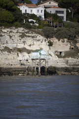 Fototapeta na wymiar traditional french fisherman's wooden hut at the bottom of the limestone cliff in the estuary of Gironde, Meschers-sur-Gironde