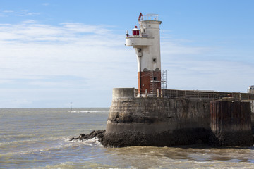 Small white and red lighthouse - Port of Royan on the Atlantic Coast, France.
