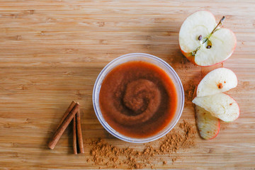 Apple butter with apple slices and cinnamon sticks