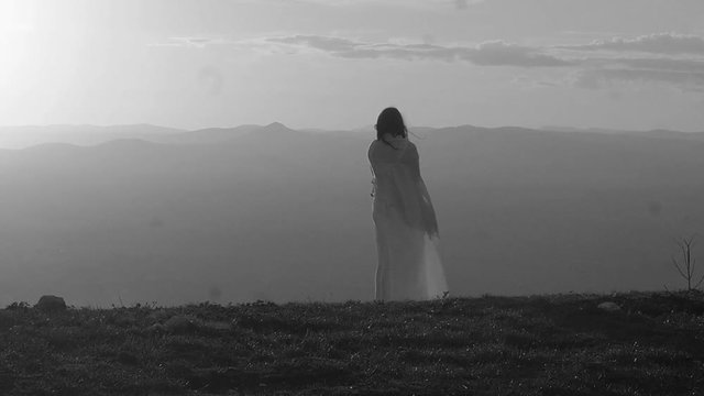 cute woman on the top of the mountain: dreamy woman viewing the plain under her