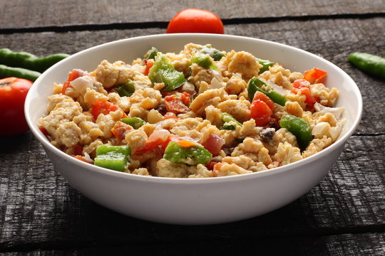 Bowl of scrambled eggs with vegetables