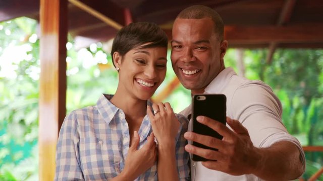 A black couple takes a  selfie to celebrate their engagement