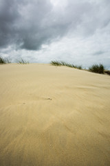 view on a sandy dune with cloudy sky