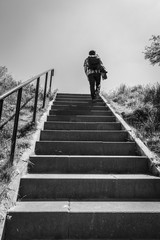 Man walking up stairs, black and white