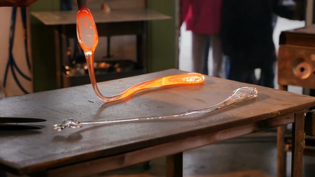 Glassblower placing a molten glass