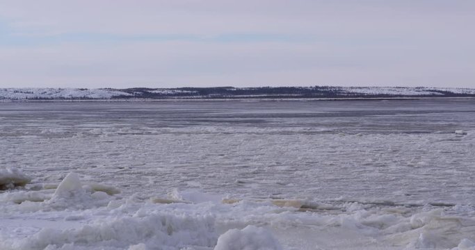 Pan with current of ice choked arctic river