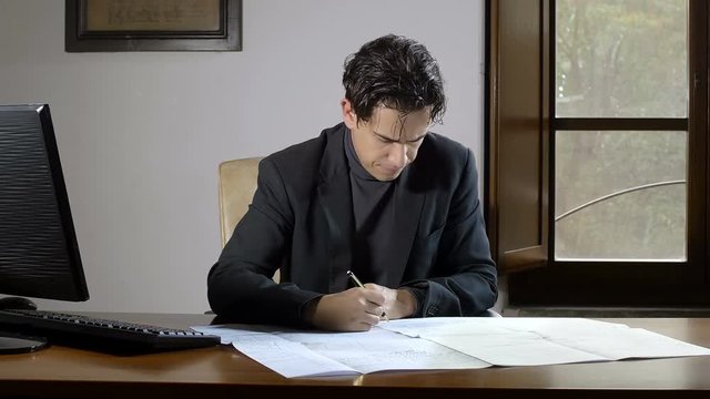 Focuse Business man writes a work document
