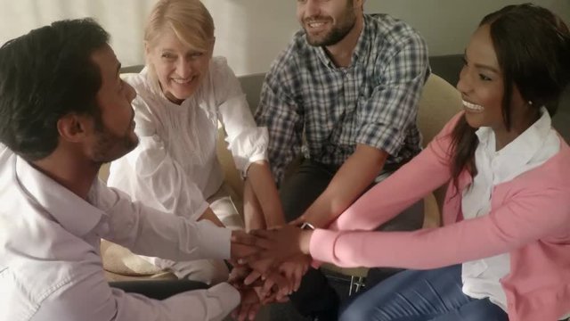 Group of business executives forming handstack