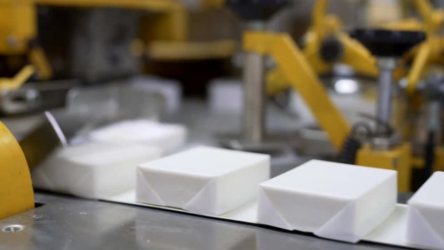 Packaging curd using machine. View of conveyor