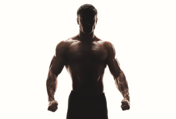 Dark silhouette of a strong man on white background. Confident young fitness man with strong hands...