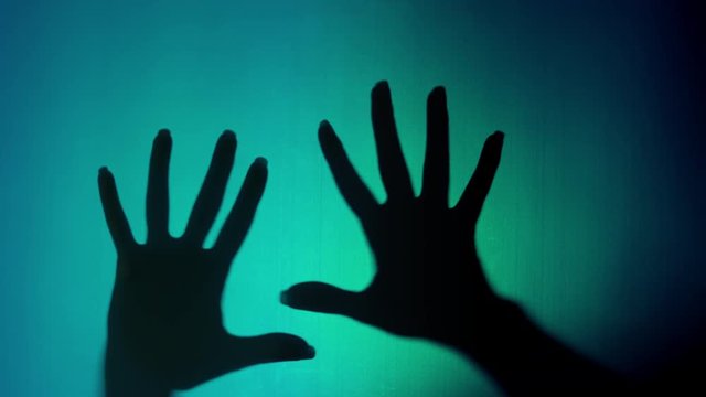 4k Halloween Shot of Shadow of Two Human Hands Through Latex