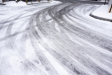 tire tracks on street after snow
