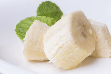 Three pieces of sweet sliced banana with mint leaves