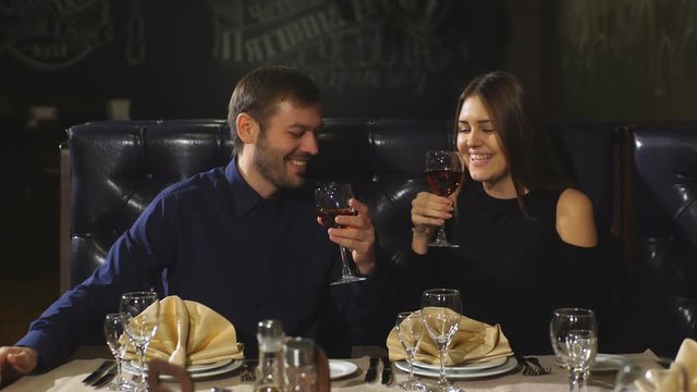 Beautiful Couple Sitting In A Fancy Restaurant And Talking