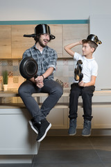 Fototapeta na wymiar father and kid having great time in kitchen. Father and son havi