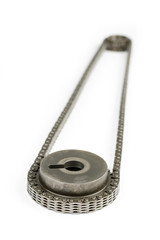 Oiled cam shaft with timing chain isolated over white background
